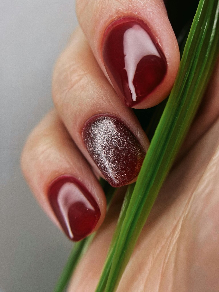Burgundy nails with glitter accent