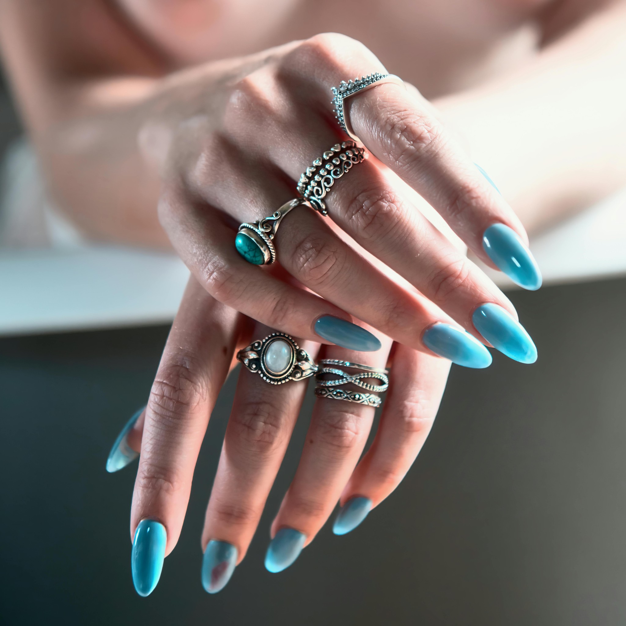 Blue almond nails with silver rings