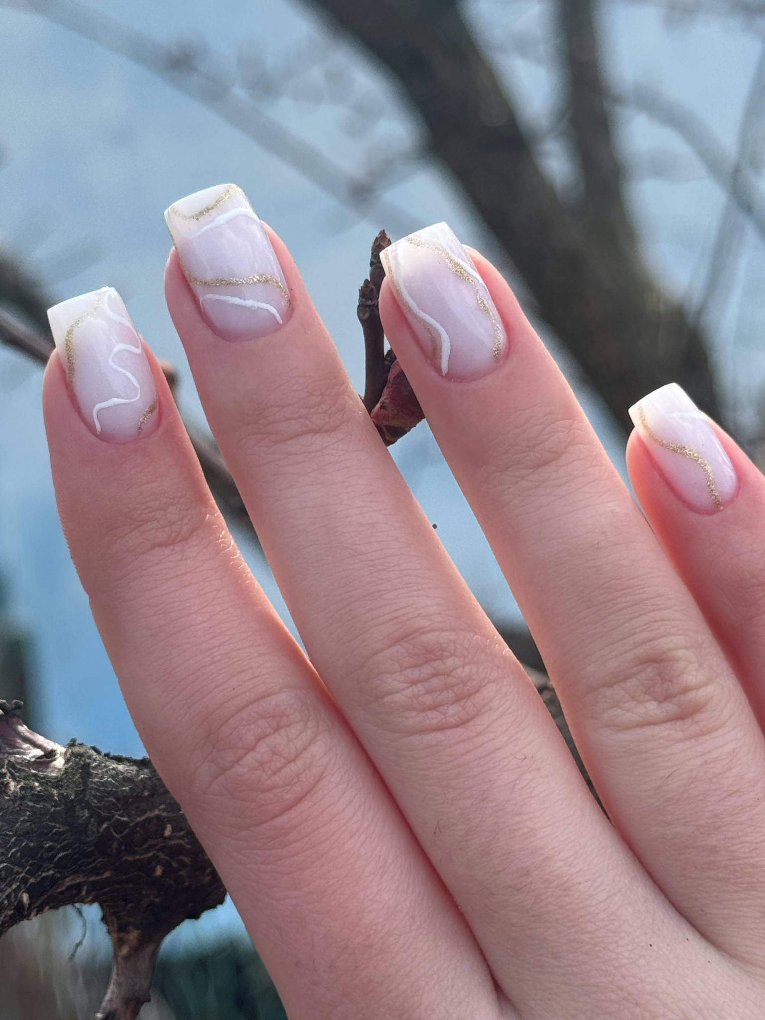 White marble nails with gold accents